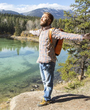 Man embracing nature by lake